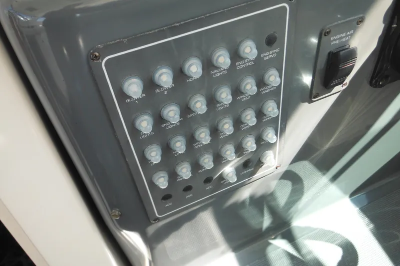 Slide: The Image of Control panel of a 2001 Tiara Yachts 3500 Open boat with labeled switches. - 115