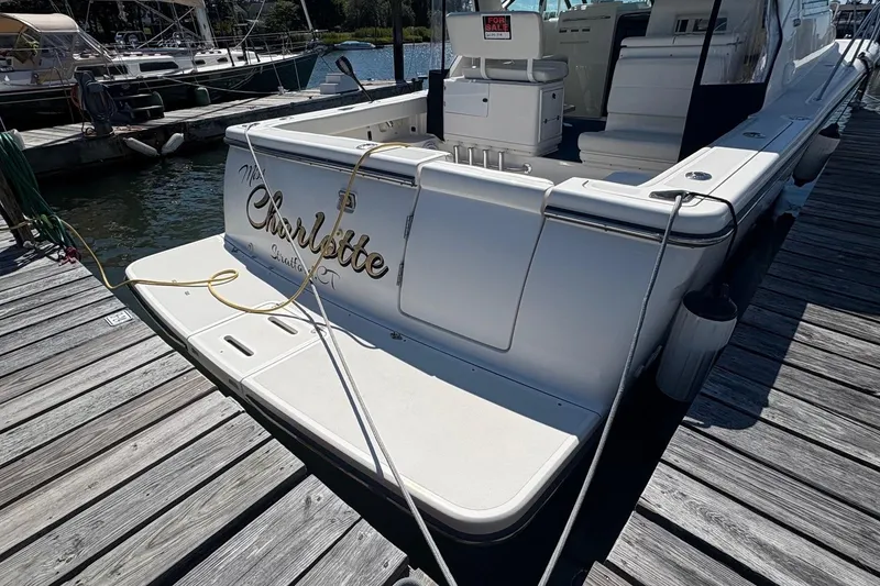 Slide: The Image of 2001 Tiara Yachts 3500 Open docked, rear view with "For Sale" sign. - 119