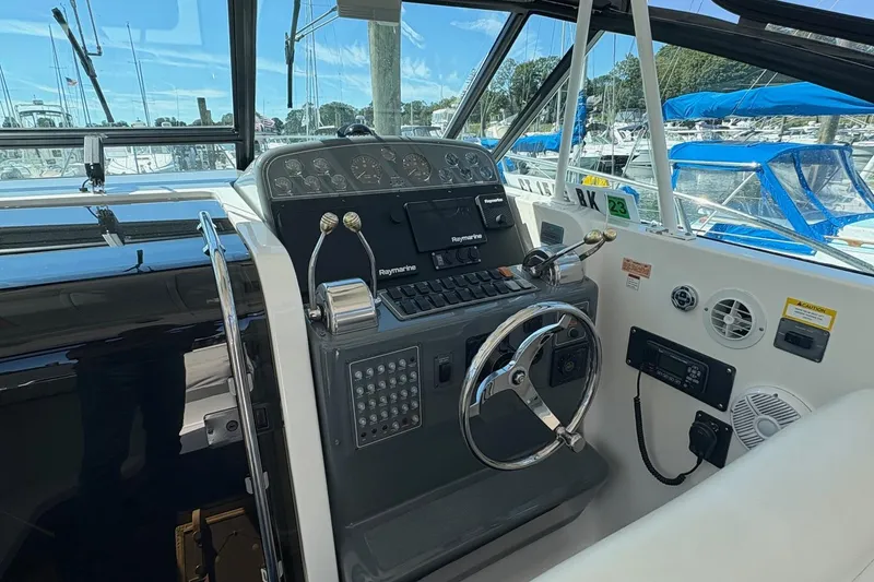 Slide: The Image of 2001 Tiara Yachts 3500 Open helm with steering wheel and navigation controls. - 123