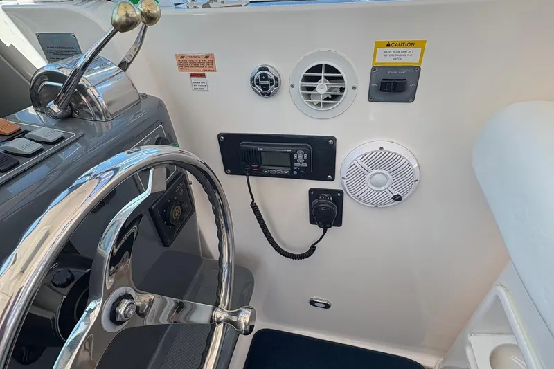 Slide: The Image of Helm of 2001 Tiara Yachts 3500 Open with steering wheel and control panel. - 125