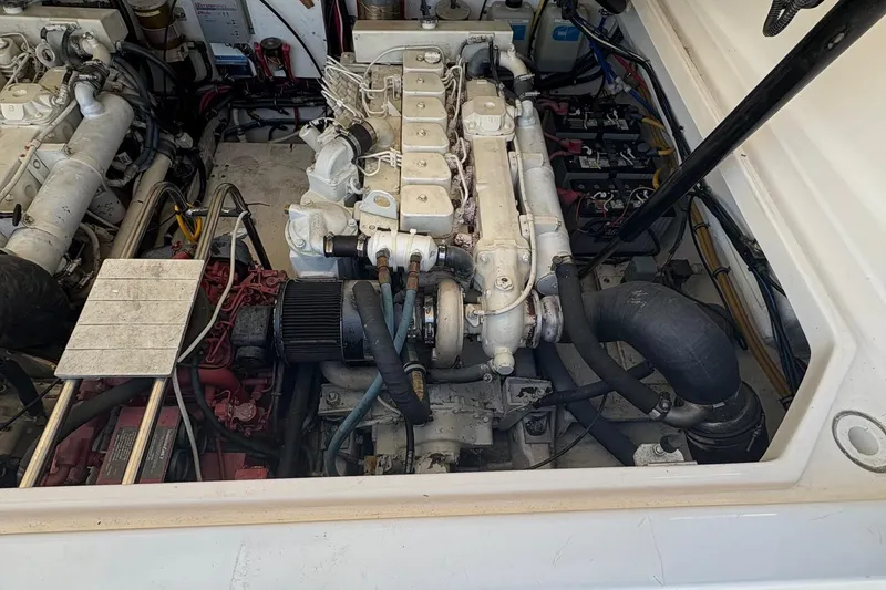 Slide: The Image of Engine compartment of a 2001 Tiara Yachts 3500 Open, showcasing mechanical components and wiring. - 128
