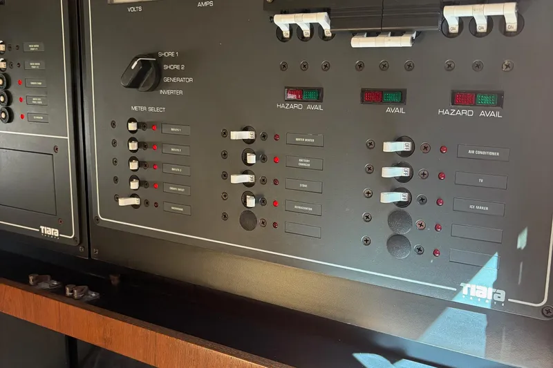 Slide: The Image of Control panel of a 2001 Tiara Yachts 3500 Open, featuring switches and indicators. - 129