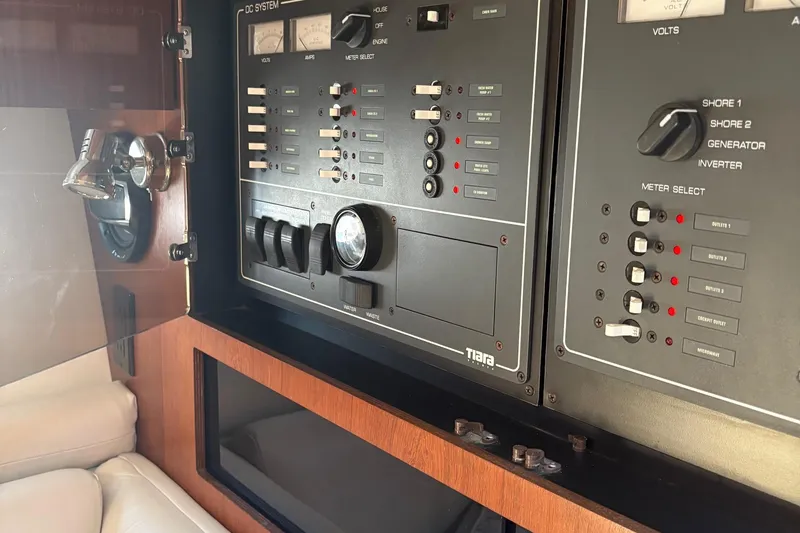 Slide: The Image of Control panel of a 2001 Tiara Yachts 3500 Open, featuring switches and gauges. - 130
