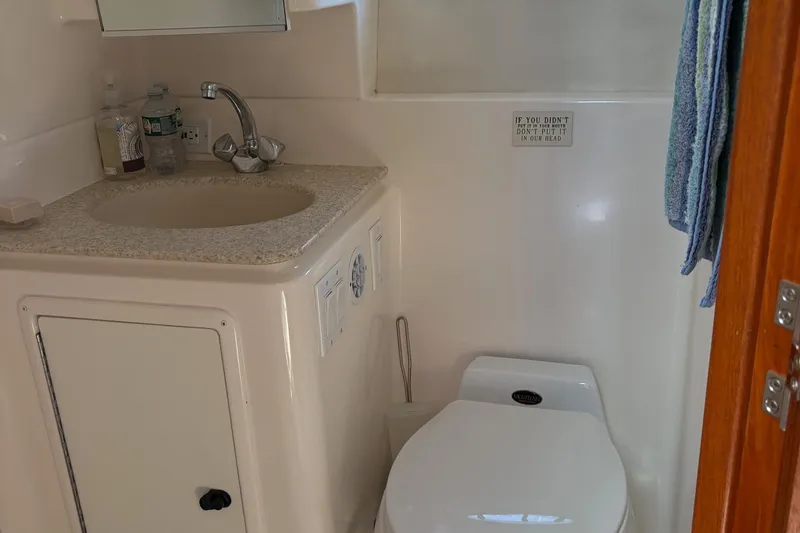 Slide: The Image of Bathroom interior of 2001 Tiara Yachts 3500 Open with sink and toilet. - 132