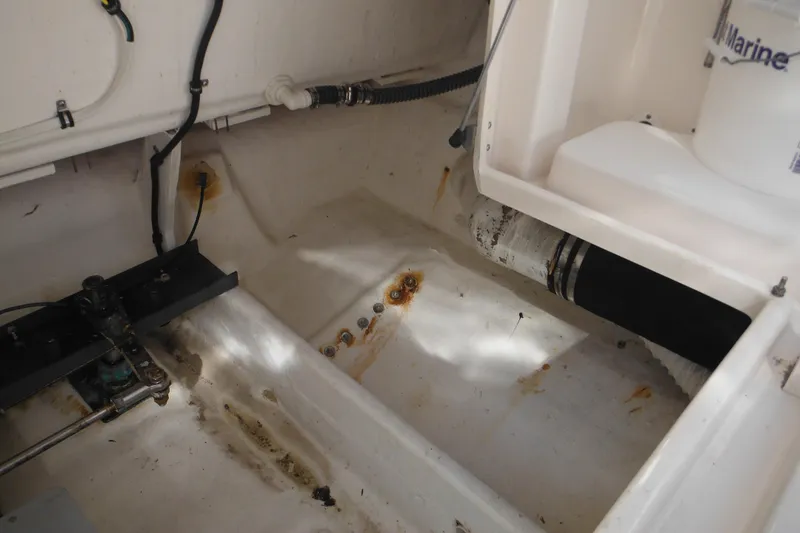 Slide: The Image of Engine compartment of a 2001 Tiara Yachts 3500 Open, showing rust and piping details. - 24