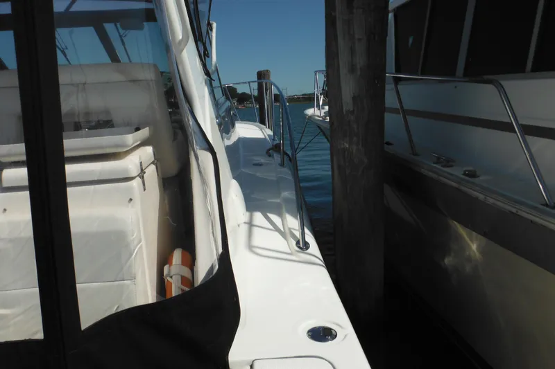 Slide: The Image of 2001 Tiara Yachts 3500 Open docked, showcasing sleek design and spacious deck. - 26