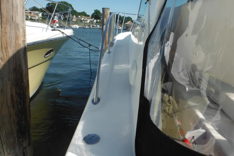 Slide: The Image of 2001 Tiara Yachts 3500 Open docked, showcasing sleek design and marina setting. - 27