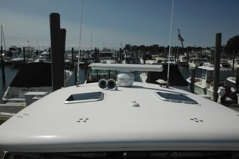 Slide: The Image of 2001 Tiara Yachts 3500 Open docked at a marina, surrounded by other boats. - 38