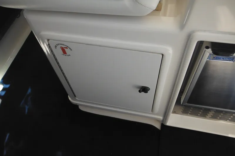 Slide: The Image of 2001 Tiara Yachts 3500 Open interior with fire extinguisher compartment and storage area. - 43