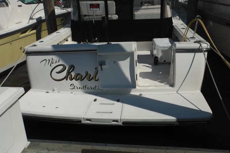 Slide: The Image of 2001 Tiara Yachts 3500 Open docked, rear view with "Miss Charlotte" name. - 5