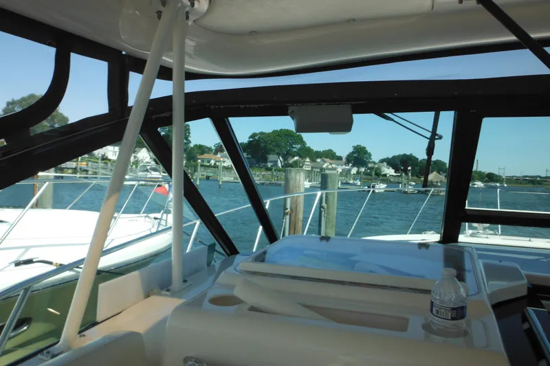 Slide: The Image of 2001 Tiara Yachts 3500 Open interior view at marina with scenic waterfront backdrop. - 61