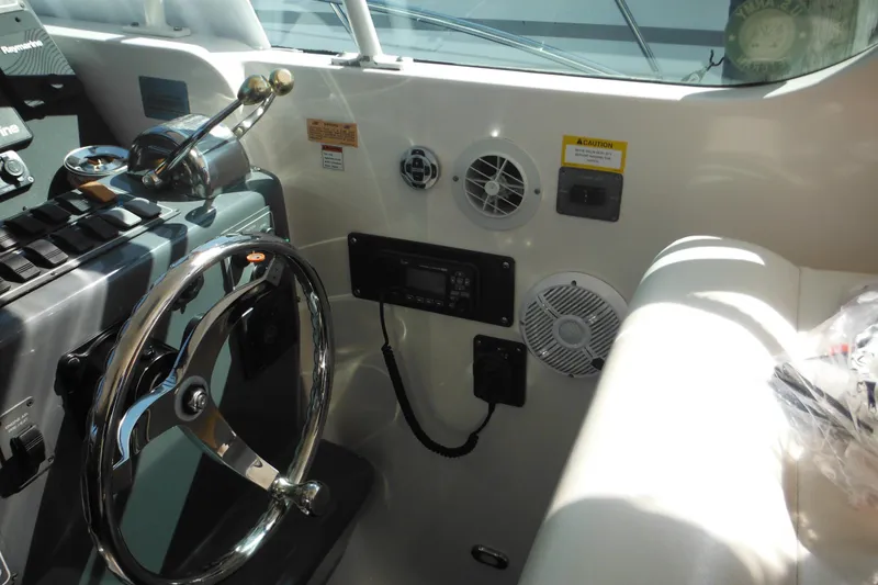 Slide: The Image of 2001 Tiara Yachts 3500 Open helm with steering wheel and control panel. - 63