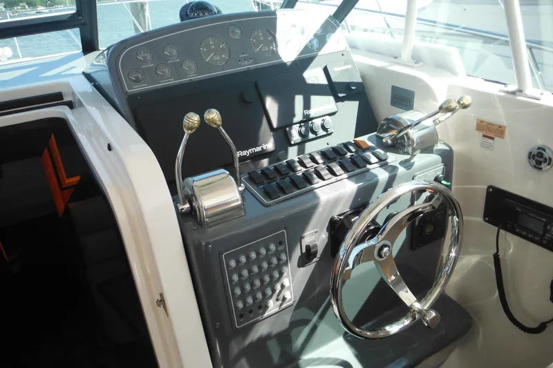 Slide: The Image of 2001 Tiara Yachts 3500 Open helm with steering wheel and control panel. - 65