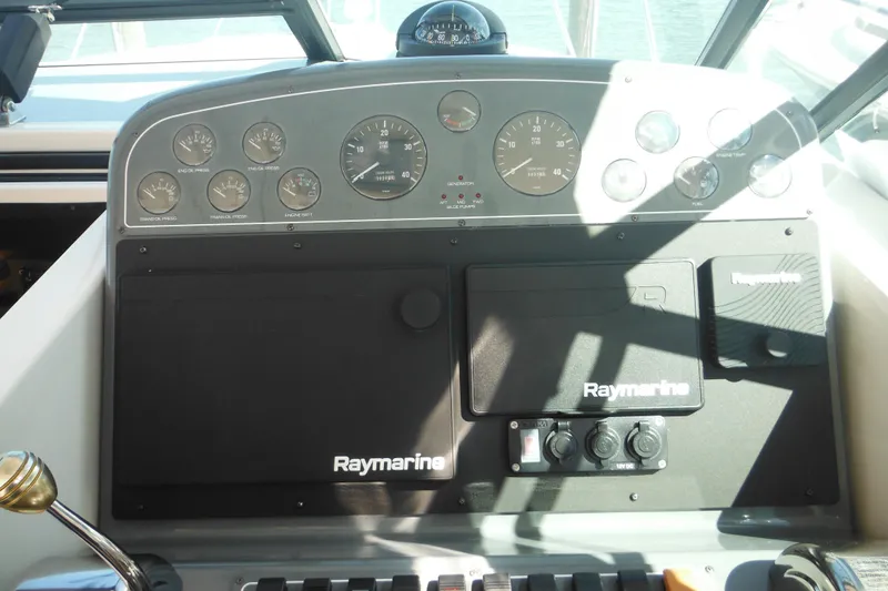 Slide: The Image of Control panel of a 2001 Tiara Yachts 3500 Open with Raymarine navigation equipment. - 68