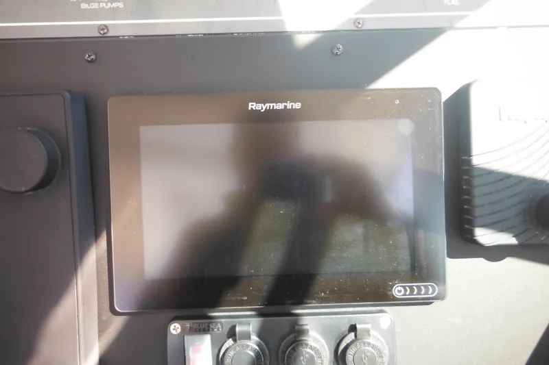 Slide: The Image of Raymarine display on 2001 Tiara Yachts 3500 Open dashboard, featuring control switches. - 70