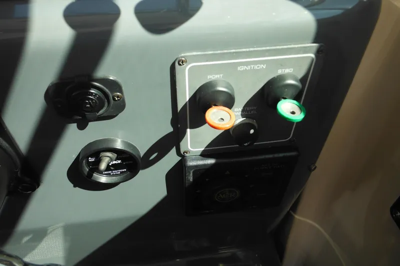 Slide: The Image of Control panel of a 2001 Tiara Yachts 3500 Open, featuring ignition switches. - 76
