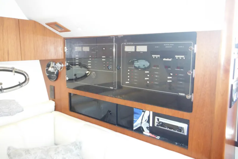 Slide: The Image of 2001 Tiara Yachts 3500 Open interior with control panel and wood finish. - 96