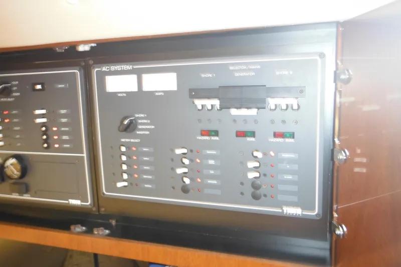 Slide: The Image of Control panel of a 2001 Tiara Yachts 3500 Open, featuring AC system switches. - 97