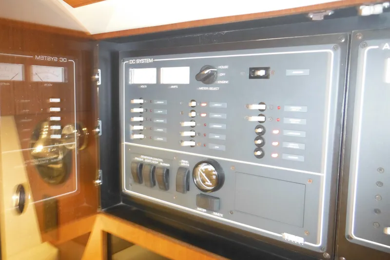 Slide: The Image of Control panel of a 2001 Tiara Yachts 3500 Open, featuring DC system switches and gauges. - 98