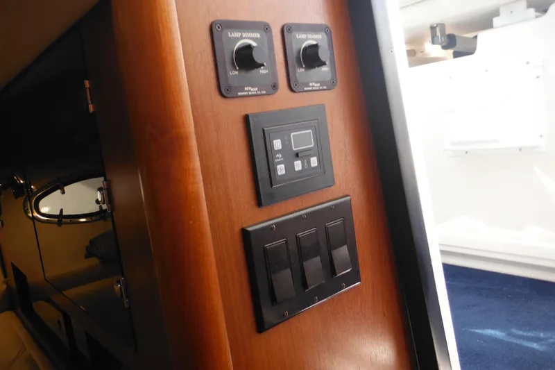 Slide: The Image of 2001 Tiara Yachts 3500 Open interior control panel with dimmer switches. - 99