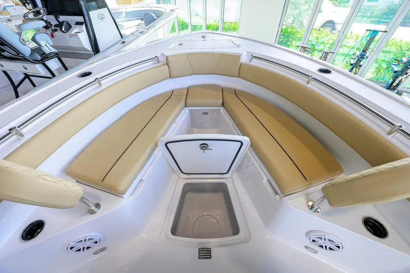 Slide: The Image of 2026 Sportsman Open 212 Center Console boat interior with tan seating and storage compartments. - 13