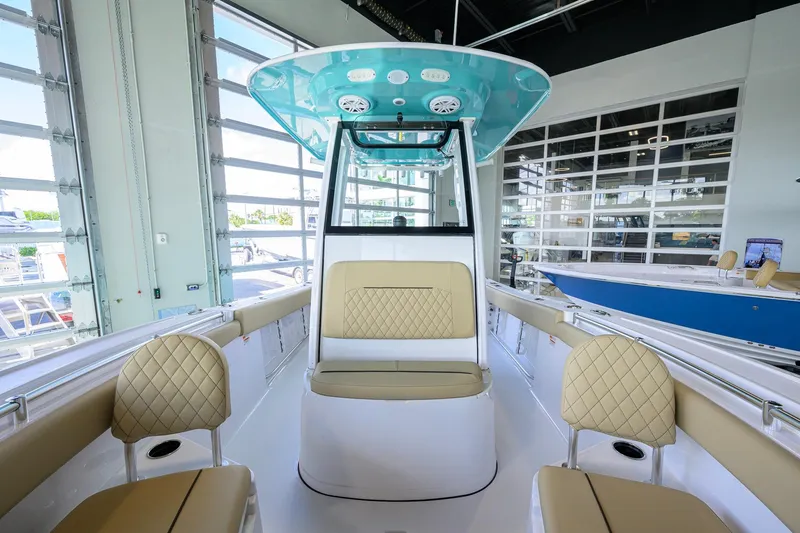 Slide: The Image of 2026 Sportsman Open 212 Center Console boat interior with tan seating and modern design. - 17