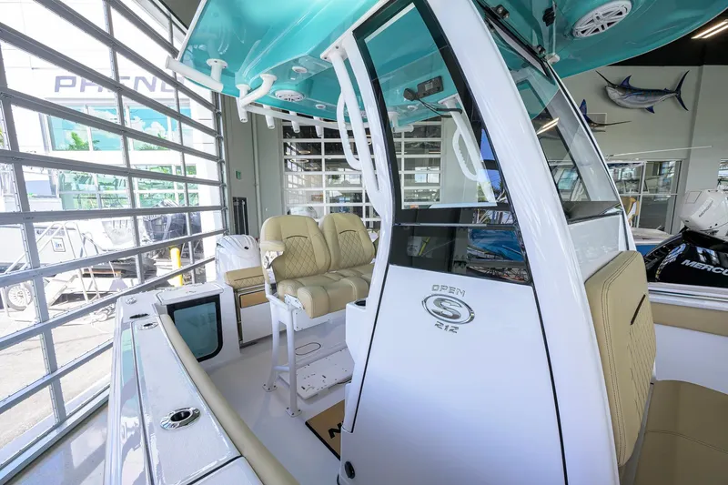 Slide: The Image of 2026 Sportsman Open 212 Center Console boat interior with beige seating and modern design. - 21