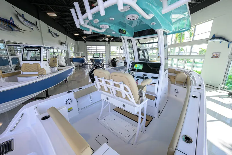 Slide: The Image of 2026 Sportsman Open 212 Center Console boat in showroom, featuring modern design and spacious seating. - 23
