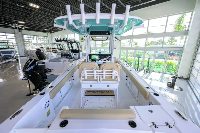 Slide: The Image of 2026 Sportsman Open 212 Center Console boat in showroom, featuring modern design and seating. - 24