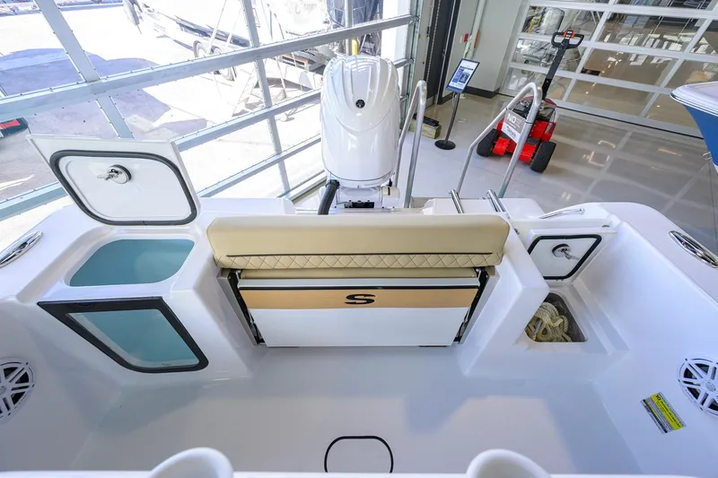Slide: The Image of 2026 Sportsman Open 212 Center Console boat interior with storage compartments and seating. - 30