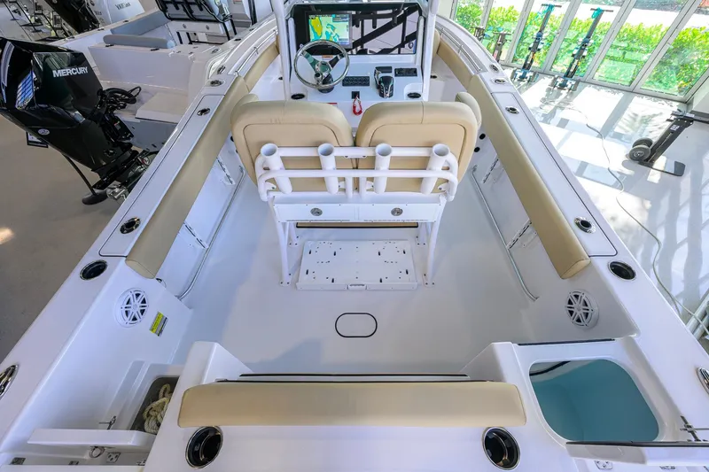 Slide: The Image of 2026 Sportsman Open 212 Center Console boat interior with beige seating and modern controls. - 32