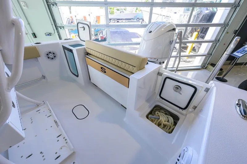 Slide: The Image of 2026 Sportsman Open 212 Center Console boat interior with storage compartments and seating. - 33