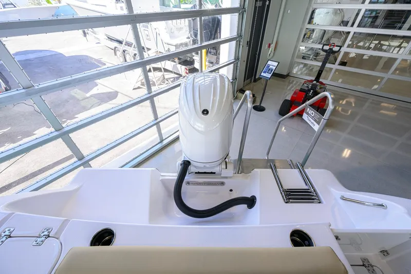 Slide: The Image of 2026 Sportsman Open 212 Center Console boat with outboard motor in showroom. - 34