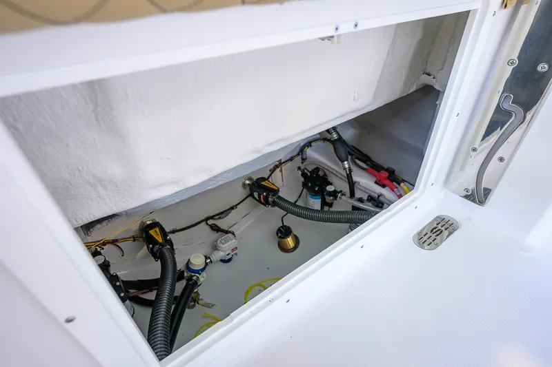 Slide: The Image of 2026 Sportsman Open 212 Center Console boat wiring and components inside compartment. - 37