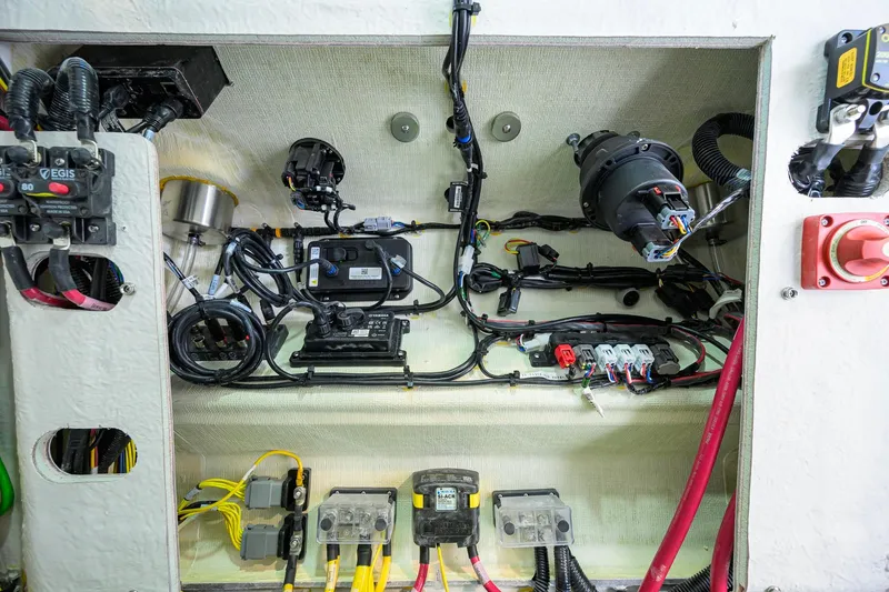 Slide: The Image of Electrical wiring and components inside a 2026 Sportsman Open 212 Center Console boat. - 44