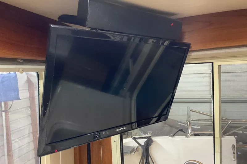 Slide: The Image of Flat-screen TV mounted inside 2002 American Tug, Hull #24, near window. - 16