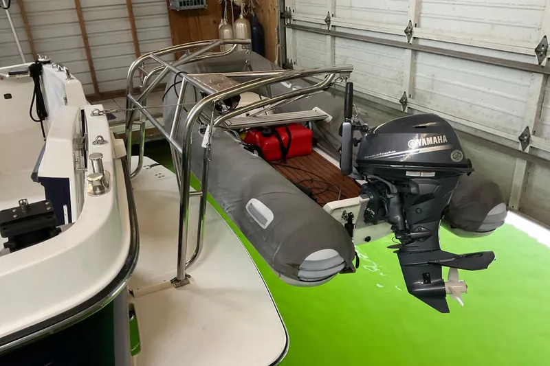 Slide: The Image of American Tug Hull #24 (2002) with Yamaha outboard motor in a garage setting. - 19