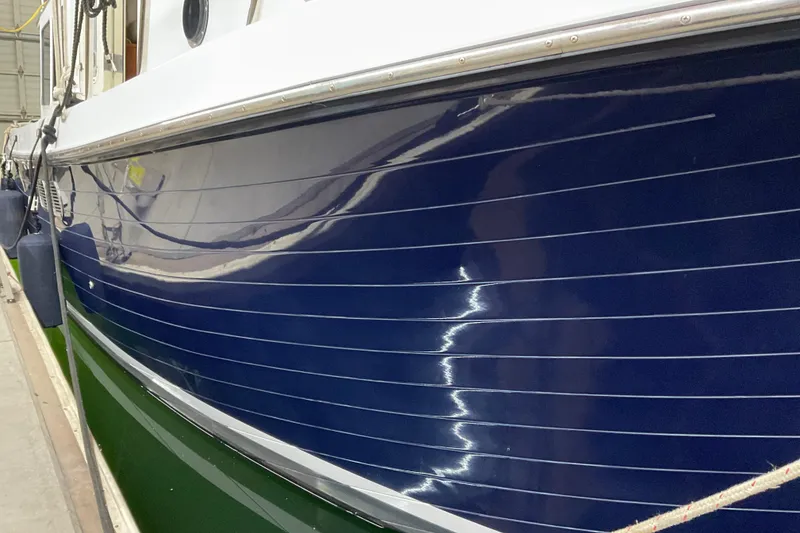 Slide: The Image of Close-up of 2002 American Tug Hull #24 with glossy blue finish. - 2