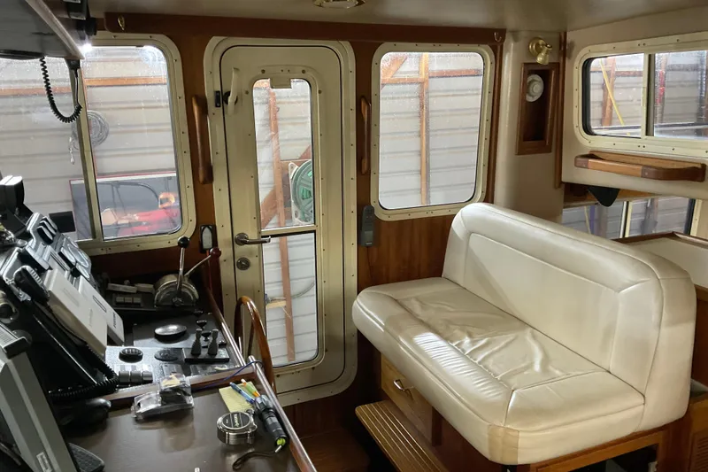 Slide: The Image of Interior of 2002 American Tug Hull #24 with helm and seating area. - 20