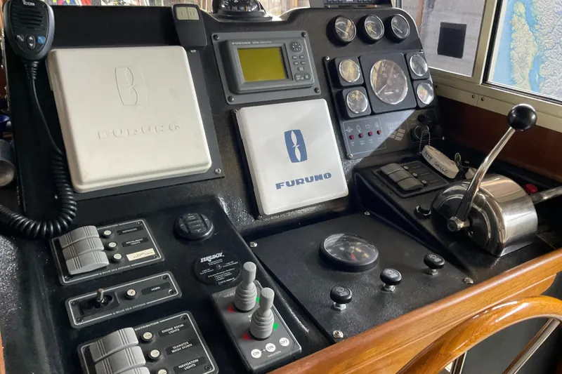 Slide: The Image of Control panel of a 2002 American Tug Hull #24 with navigation and communication equipment. - 21