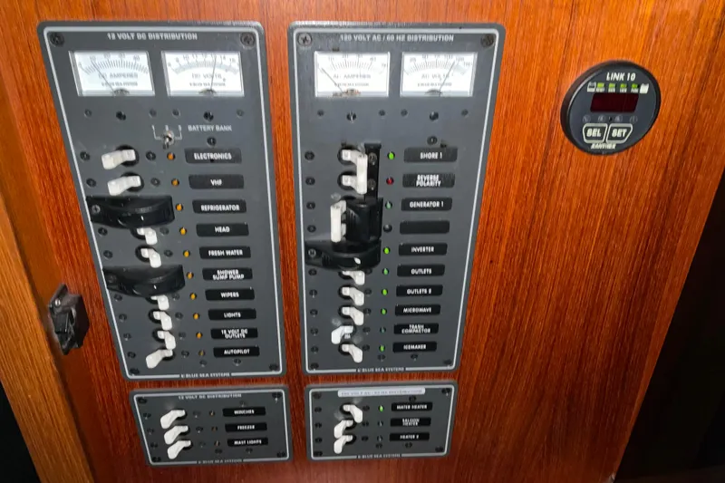 Slide: The Image of Electrical panel of 2002 American Tug Hull #24 with switches and gauges. - 24