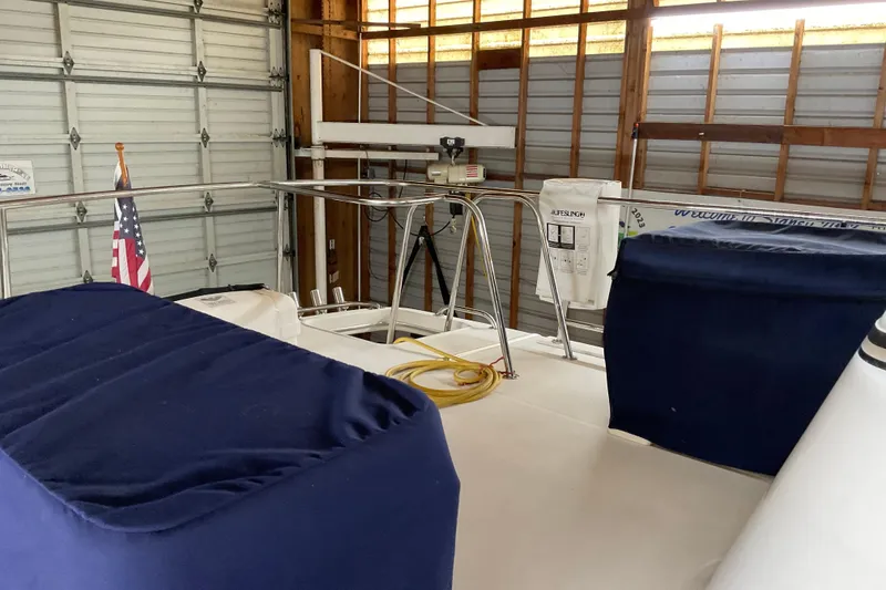 Slide: The Image of American Tug Hull #24, 2002 model, in a garage with blue covers and an American flag. - 29