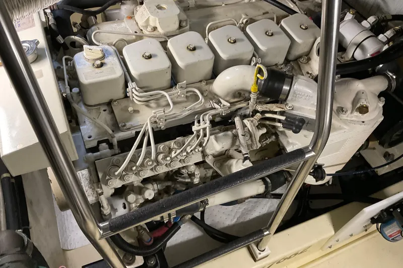 Slide: The Image of Engine compartment of 2002 American Tug Hull #24, showcasing mechanical components and piping. - 31