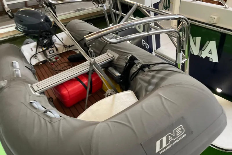 Slide: The Image of Inflatable boat on American Tug Hull #24, 2002 model, with outboard motor and red fuel tank. - 33