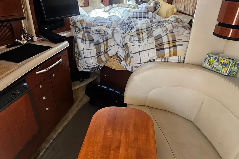 Slide: The Image of Interior of 2005 Sea Ray 300 Sundancer with cozy bed and kitchenette. - 10
