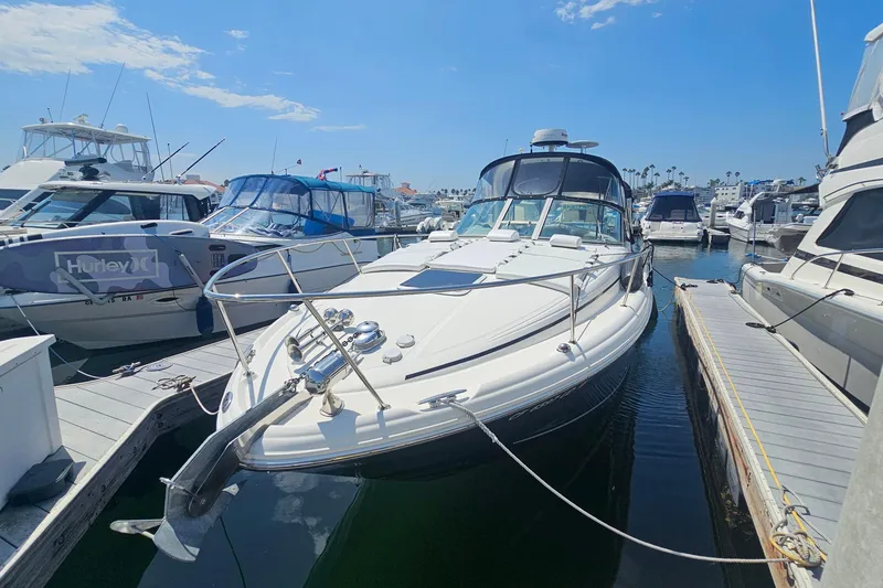 Slide: The Image of 2005 Sea Ray 300 Sundancer docked at marina under clear blue sky. - 2