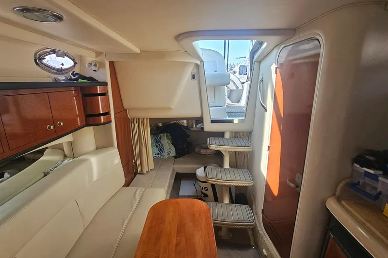 Slide: The Image of Interior of 2005 Sea Ray 300 Sundancer boat with seating and wooden cabinetry. - 6