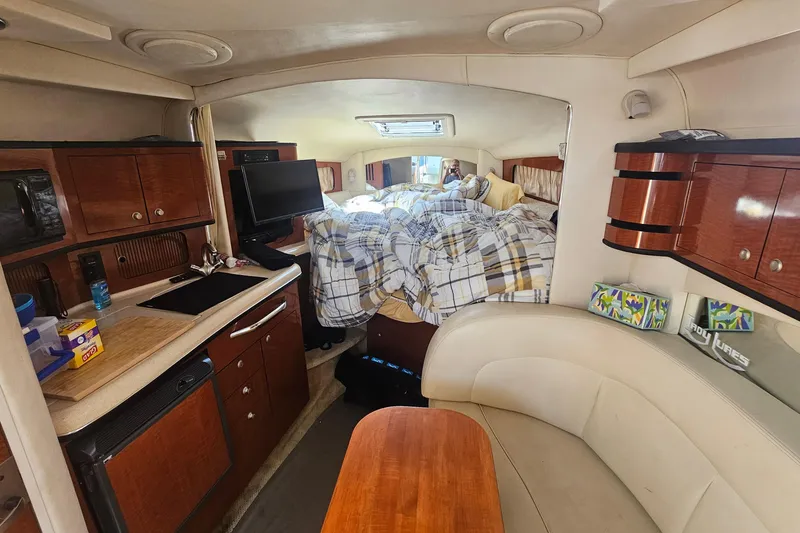 Slide: The Image of Interior of 2005 Sea Ray 300 Sundancer with cozy cabin and modern amenities. - 9