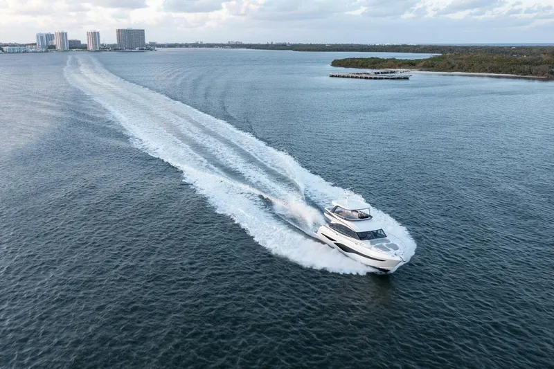 Slide: The Image of Luxurious 2026 Princess F65-079 yacht cruising on open water near city skyline. - 22