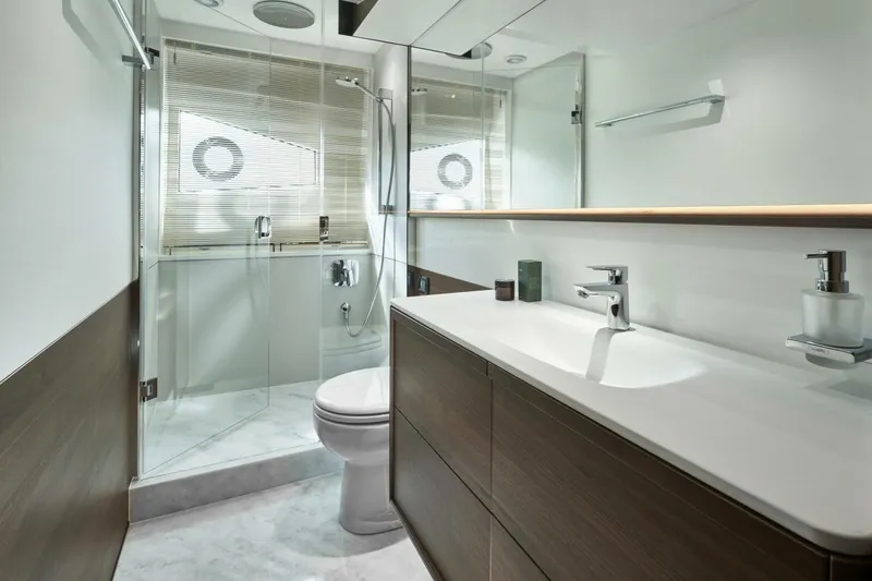 Slide: The Image of Modern yacht bathroom with sleek fixtures, glass shower, and wood accents, Princess F65-079, 2026 model. - 9